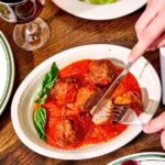 Person cutting into a meatball