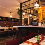 Cozy dining area with bar displaying Spaghetti Incident tees and hoodies