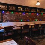 Intimate restaurant with wooden tables against rustic brick walls