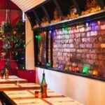 Rustic brick-walled dining space softly lit for intimacy